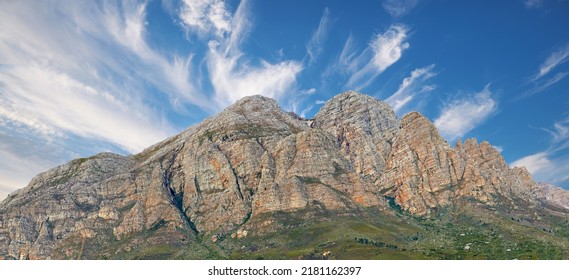 Landscape View Of A Mountainside With Copy Space And Blue Sky Background From A Lush, Green Botanical Garden Or National Park. Low Angle Of Rough, Rocky, Or Dangerous Terrain In A Remote Location