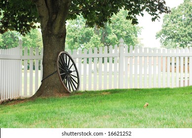 Landscape view of an old spoked wheel chained to a tree