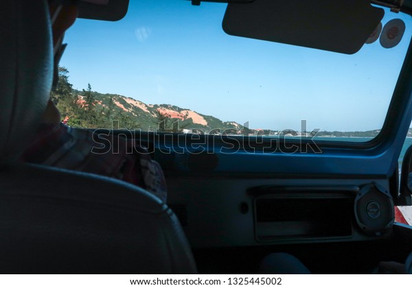 Landscape view from the riding car window\
on the beach road, Mui Ne, Vietnam. On Dec 9,\
2018.