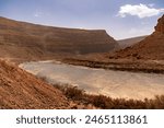 A landscape view of the semi-desert of the Ziz Valley and Ziz Valley Gorge and its dry riverbed