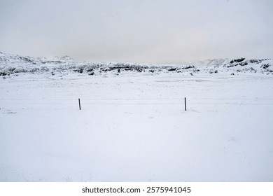 Landscape view of snow covered fields and mountain ranges in Iceland. Nature, travel, winter background, or wallpaper