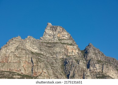 Landscape View Of Table Mountain In Cape Town, South Africa With Blue Sky And Copy Space. Low Angle Of A Steep, Rough And Rugged Famous Hiking Terrain. Risky And Dangerous Challenge To Climb The Peak