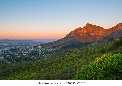 Landscape view of the Table Mountain national park and the cityscape of Cape Town at sunset, Western Cape Province, South Africa.