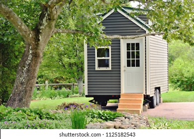 Landscape view of a tiny gray eco friendly house on wheels