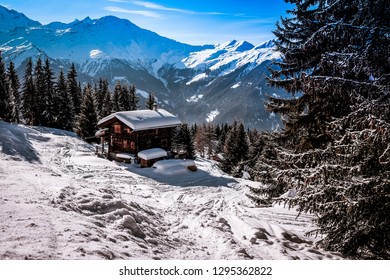 Landscape View Of A Traditional Wooden Chalet With The Roof Covered By Snow, In The Ski Resort Of 