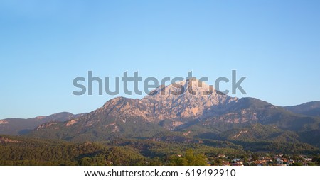Landscape - village in the mountains, blue sky, green plants. View of Mount Olympus, Tekirova (Turkey, Antalya, Kemer). Mediterranean coast of Lycia, Tahtali mountains.