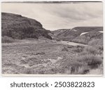 Landscape vintage photo in gray tones, depicting a beautiful steppe, river and rocky cliffs. This old photo was taken in the ussr around 1960-1970.