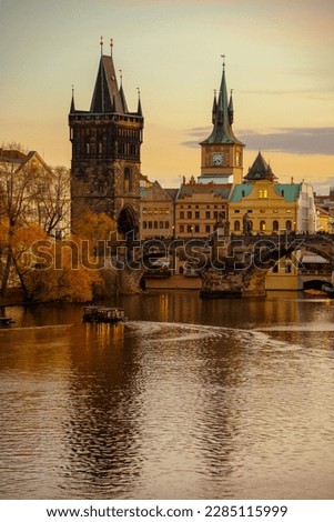 landscape with Vltava river and Charles Bridge at sunset in autumn in Prague, Czech Republic.