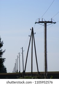 Landscape with voltage current line. View of electrical distribution in perspective. Power supply poles construction in nature.