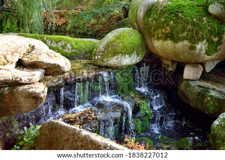 landscape, waterfall, large gray stones with moss, close-up as texture for background,