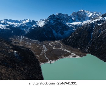 Landscape of Yilhun Lhatso and snow capped mountains in Sichuan province,China - Powered by Shutterstock