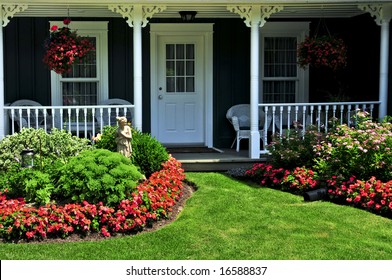 Landscaped Front Yard Of A House With Flowers And Green Lawn