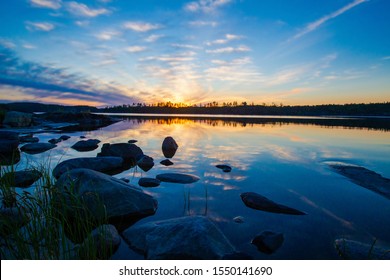 Landscapes Of Finland. Summer Sunset Over The Lake. Wildlife Of The North. Coast. Northern Nature Of Finland. Traveling In Finland. Northern Europe. Suomi. Grass Near The Shore.