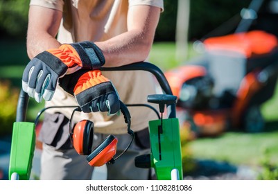 Landscaping Contractor Work. Caucasian Gardener With His Equipment.