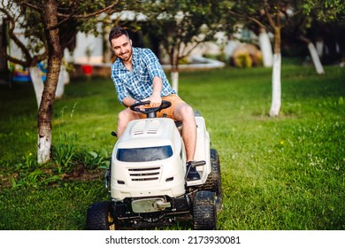 Landscaping Details - Professional Gardener Smiling And Mowing Lawn, Cutting Grass In Garden