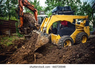 Landscaping Works With Bulldozer And Excavator At Home Construction Site