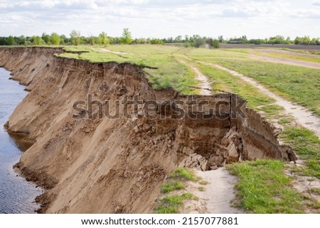 Landslide on the river bank. Dangerous road near river [[stock_photo]] © 