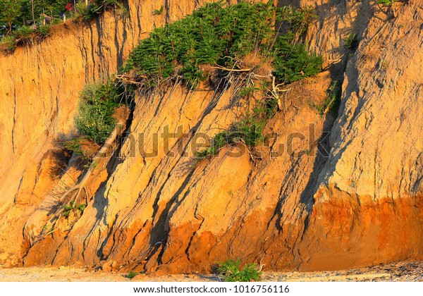 Landslide, rockfall on steep slopes of limestone\
mountains of northern Black Sea coast. Zone of natural disasters\
during rainy season. Large masses of earth slip along slope of\
hill, destroy\
houses.