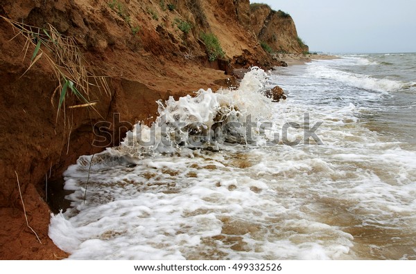 The
landslide, rockfall on the steep slopes of the limestone mountains
of the northern Black Sea coast. Dramatic moment slipping hillside.
avalanche danger for tourists on wild beach.
