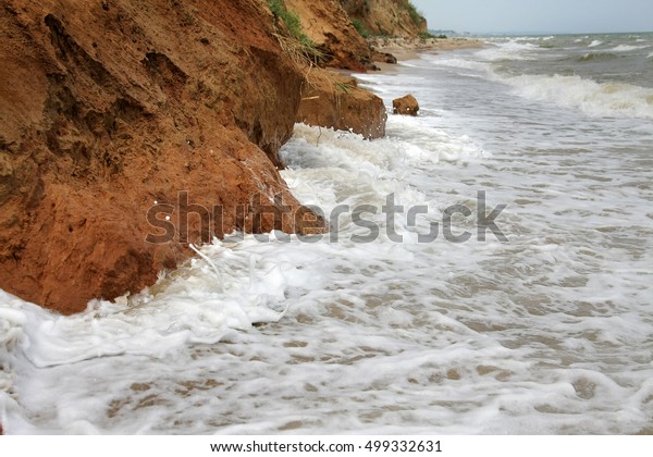 The
landslide, rockfall on the steep slopes of the limestone mountains
of the northern Black Sea coast. Dramatic moment slipping hillside.
avalanche danger for tourists on wild beach.
