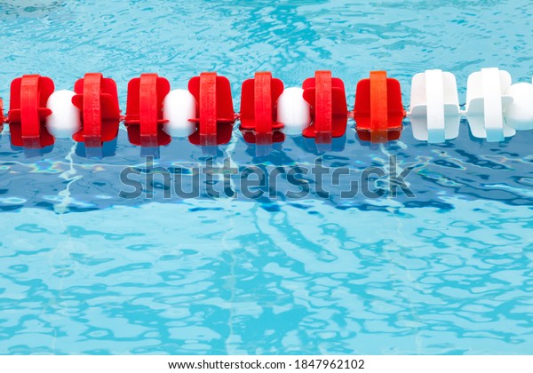 Lane\
divider, pool marker lines. Line dividers pool. Blue, red and\
white. Blue clean water. Horizontal\
background.