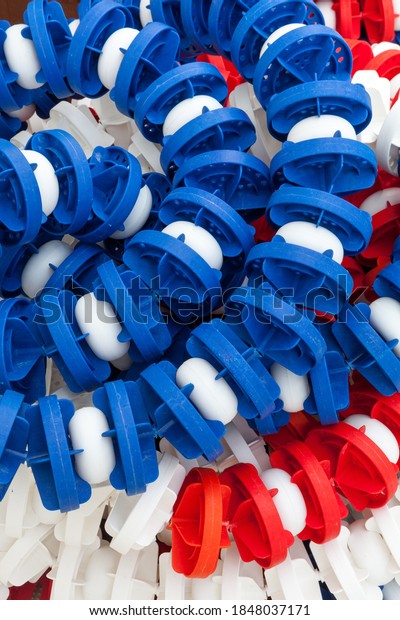 Lane divider, pool marker lines. Piled and\
stacked. Line dividers pool piled, full image. Blue, red and white.\
Full background. Plastic\
material.