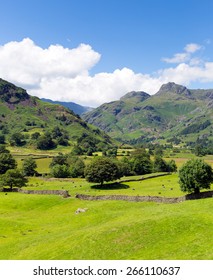 Langdale Valley Lake District Cumbria With Mountains Blue Sky And Clouds On Beautiful Summer Day 