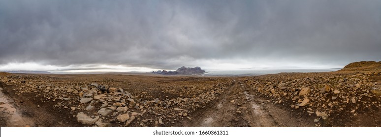 Langjokull Glacier behind huge muddy and rocky wasteland in the heart of central iceland