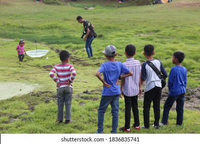 LANGKAWI,MALAYSIA - MARCH 20, 2019: Unidentified Group Of Child Waiting And Looking For Kid Stuck In  In Natural Quicksand River, Clay Sediments, Sinking, Drowning Quick Sand, Stuck In The Soil