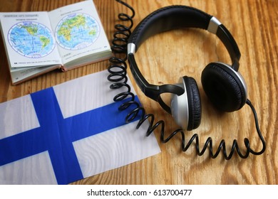 language course headphone and flag on wooden table
