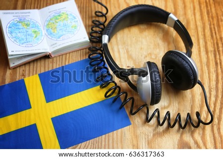 language course headphone and flag on wooden table
