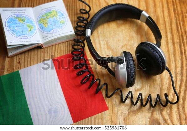 language course\
headphone and flag on wooden\
table