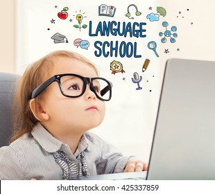 Language School Concept With Toddler Girl Using Her Laptop