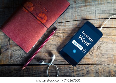 Language Translation App In A Mobile Phone Screen Over A Wooden Table