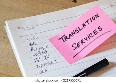 Language Translation Concept. Hello In Different Languages Written On Notebook With Translation Services Memo On Sticky Note On Desk. Selective Focus.