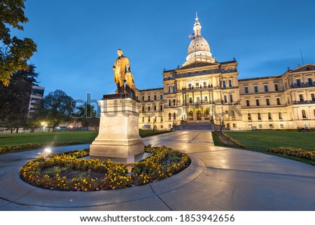 Lansing, Michigan, USA at the Michigan State Capitol during the evening. (Governor Austin Blair statue dedicated in 1898)