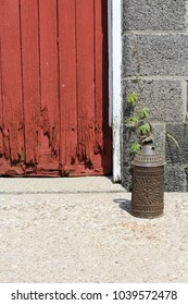 Lantern By Red Barn Door. Punched Tin Antique Lantern