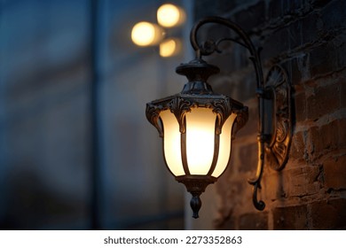 Lantern light on wall of building at night. Vintage european design lantern hanged on wall at night. Street lantern wall mounted, yellow warm light in evening. 
 - Powered by Shutterstock