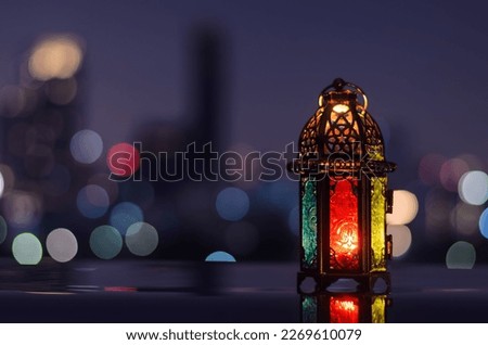 Lantern with night sky and city bokeh light background for the Muslim feast of the holy month of Ramadan Kareem.