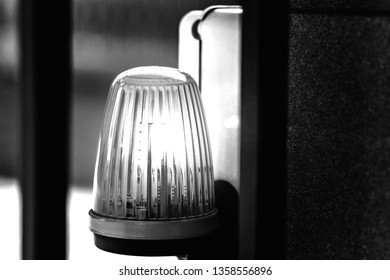 Lantern on the automatic gate warning of danger. The background is blurred. Shallow depth of field.