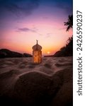 Lantern on the sand with sunset sky, Ramadan Kareem and Eid Mubarak photography
