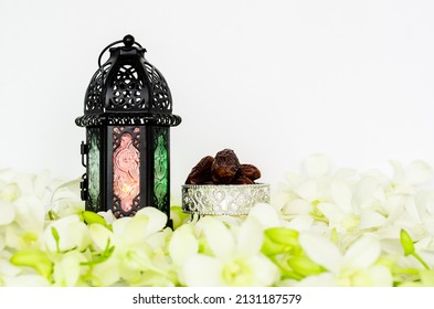 Lantern On White Background With Dates Fruit On Orchid Flower For The Muslim Feast Of The Holy Month Of Ramadan Kareem.