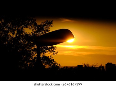 Lantern with sunset and trees and some clouds