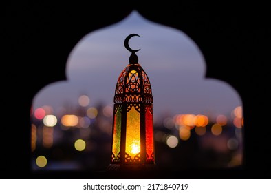 Lantern that have moon symbol on top with blurred focus of paper cut for mosque shape background. Ramadan Kareem and Islamic new year concept. - Powered by Shutterstock