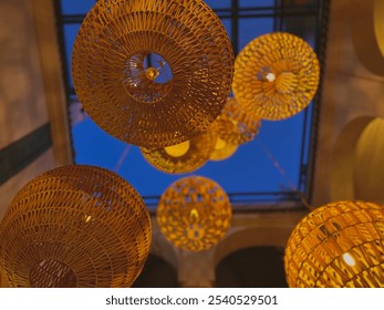 Lanterns glowing overhead, casting a warm light from above.
