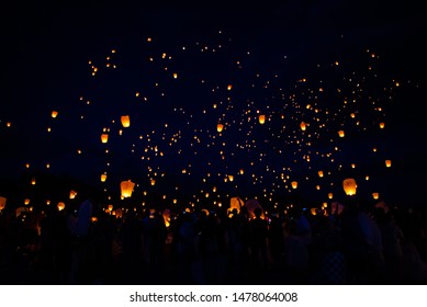 Lanterns are released into the night sky. 