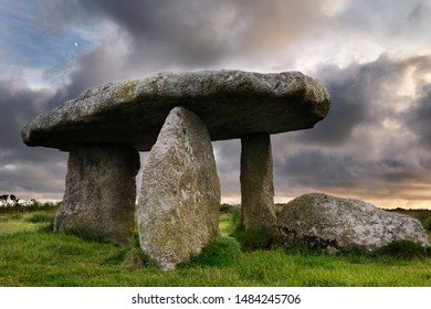 Lanyon Quoit dolmen neolithic tomb stones with three megalithic legs and 12 ton table capstone in Cornwall England at sunset with moon