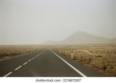 Lanzarote Road In Haze With Volcanic Rock