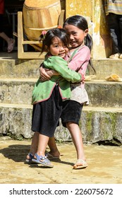 LAO CHAI VILLAGE, VIETNAM - SEP 22, 2014: Unidentified Hmong two little girls play together on a break in a local primary school. Hmong is on of the minority eethnic group in Vietnam