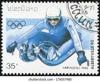 LAOS - CIRCA 1990: A Stamp Printed In Laos Shows Toboggan , 1992 Winter Olympics, Albertville, France Circa 1990